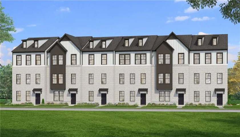 Modern townhome facade featuring light-colored brick, vertical siding, and dark trim accents