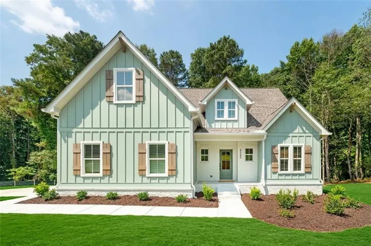 Craftsman-style exterior featuring board and batten siding, multiple gables, natural wood-finish shutters, and a covered entry