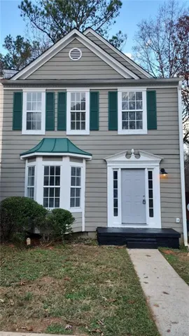 Two-story exterior with horizontal siding and a prominent front entry