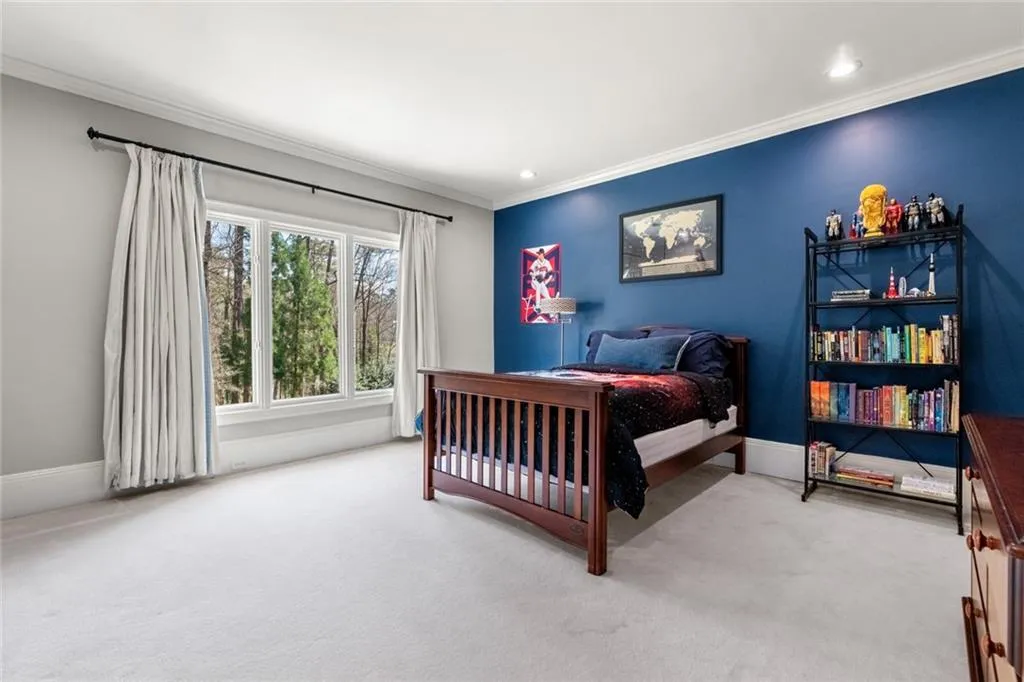 This spacious secondary bedroom features large windows that fill the room with natural light, and ample space for comfortable living. The clean, neutral flooring and bright atmosphere make it both inviting and versatile. This room has it's own ensuite and walk-in closet.