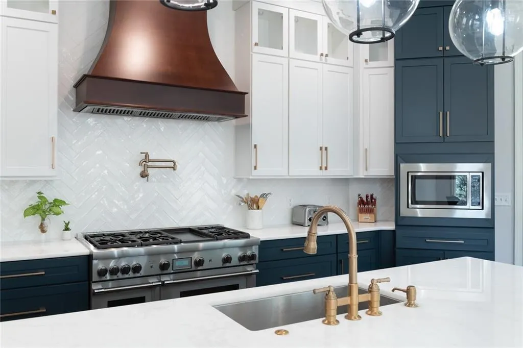 This chef s kitchen features a professional-grade gas cooktop complemented by custom full-height cabinetry, offering both high performance and exceptional storage.