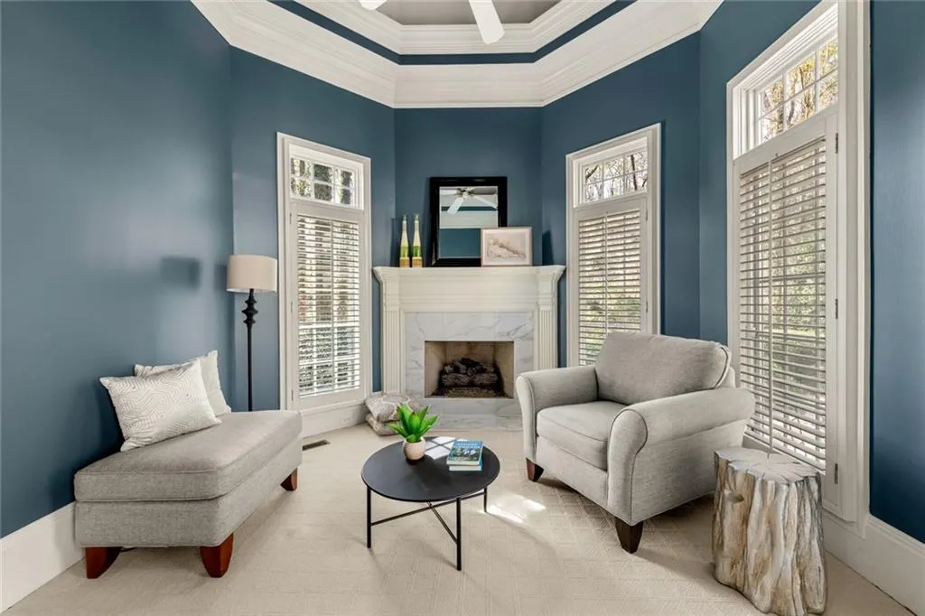 This private sitting area within the primary suite offers a quiet, separate space ideal for a home office or relaxation. Tucked away from the bedroom, it provides both comfort and privacy while maintaining a cohesive suite layout.