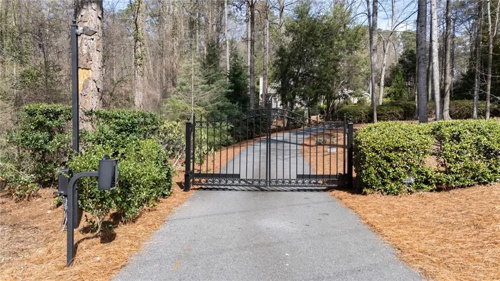 A stately gated entrance welcomes you into this private 2.3-acre estate, offering both security and a grand sense of arrival. Framed by manicured landscaping and mature trees, the gate opens to a serene, secluded retreat set well back from the road.