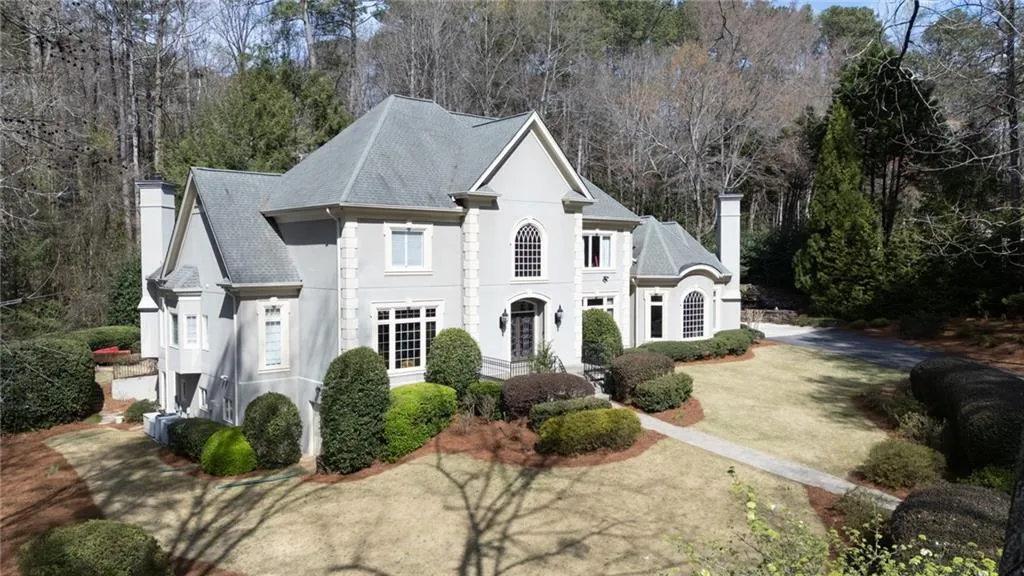 This elegant European-style residence showcases timeless architecture with its stately fa ade, arched windows, and refined detailing. Set on a beautifully landscaped lot with a sweeping driveway, the home offers both impressive curb appeal and a sense of private, estate-style living.