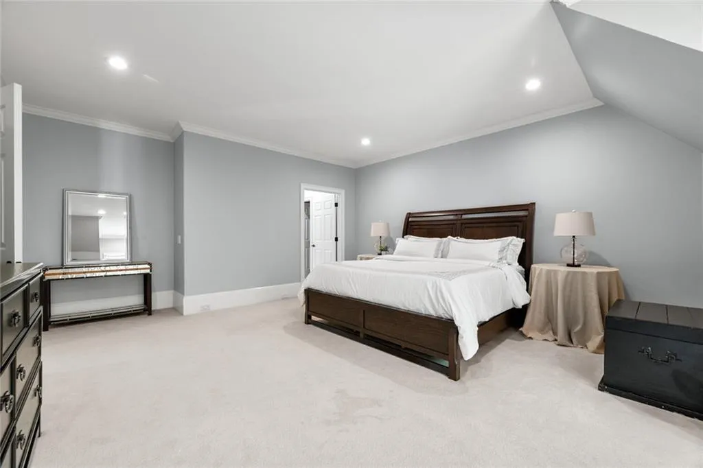 This spacious secondary primary suite offers ample room for a comfortable sitting area and additional furniture, creating a relaxing and versatile retreat.