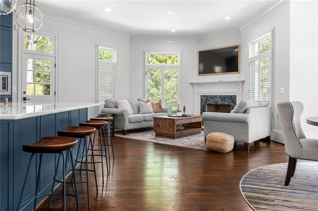 This bright and inviting keeping room flows seamlessly from the kitchen, featuring a cozy fireplace and abundant natural light. With bar seating and open sightlines, it s the perfect space for casual gatherings and everyday living.