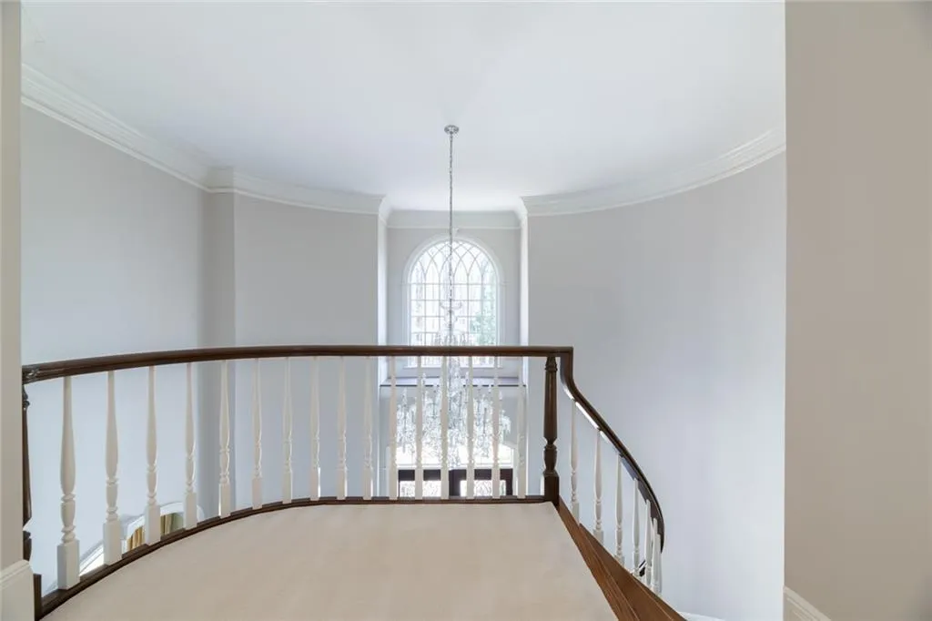 Let's transition from the main level to the upper level via the curved staircase.