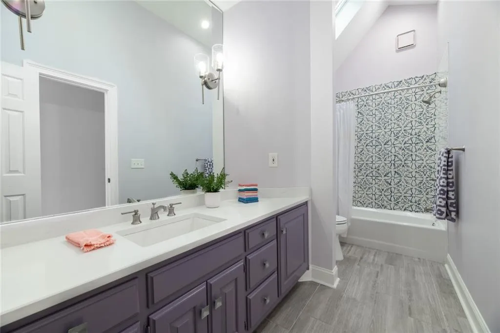 Remodeled ensuite in secondary bedroom on upper level.