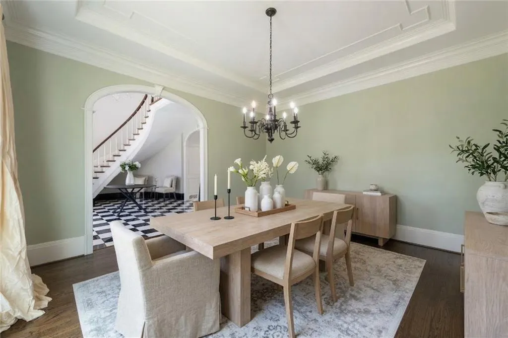 This elegant formal dining room offers a refined setting for entertaining, with beautiful detailing and ample space for gatherings. Open sightlines toward the foyer enhance the home s grand, connected feel.