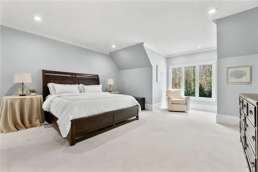This expansive secondary primary suite offers a spacious layout with soft neutral tones and a private ensuite bath for added comfort and convenience. Thoughtfully designed, it provides a peaceful retreat ideal for guests or multi-generational living.