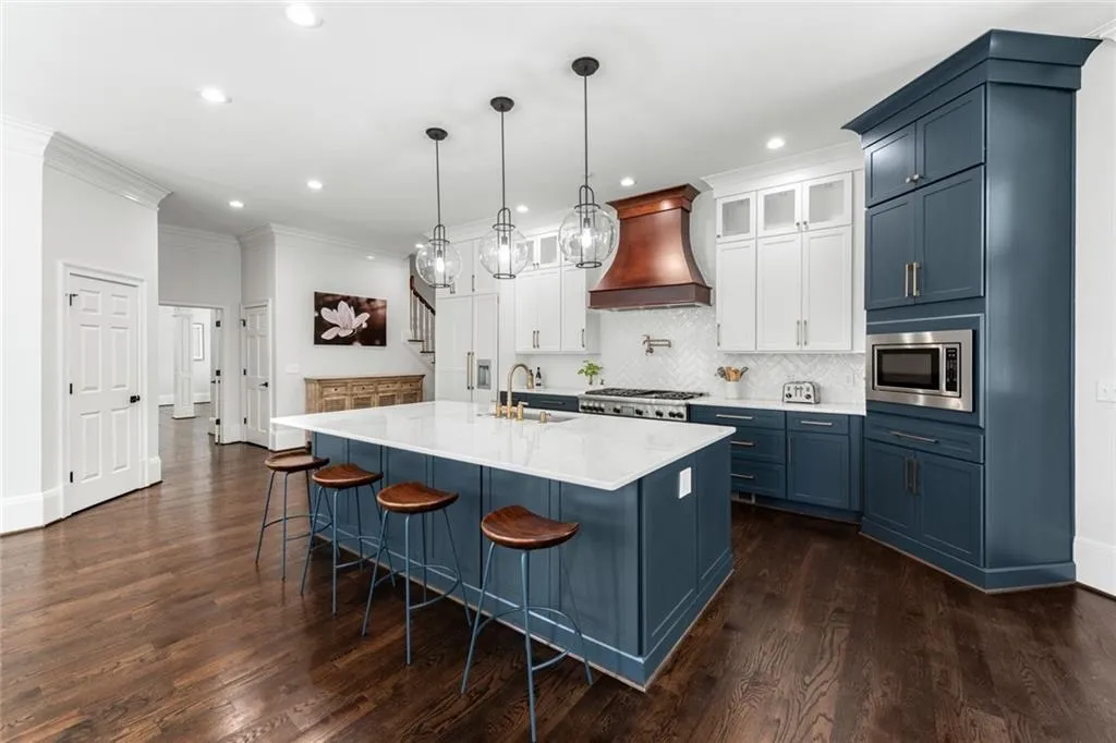 This beautifully remodeled kitchen showcases custom cabinetry, a striking center island, and high-end finishes that blend style with functionality. Thoughtfully designed with modern appliances and abundant workspace, it s perfect for both everyday living and entertaining.