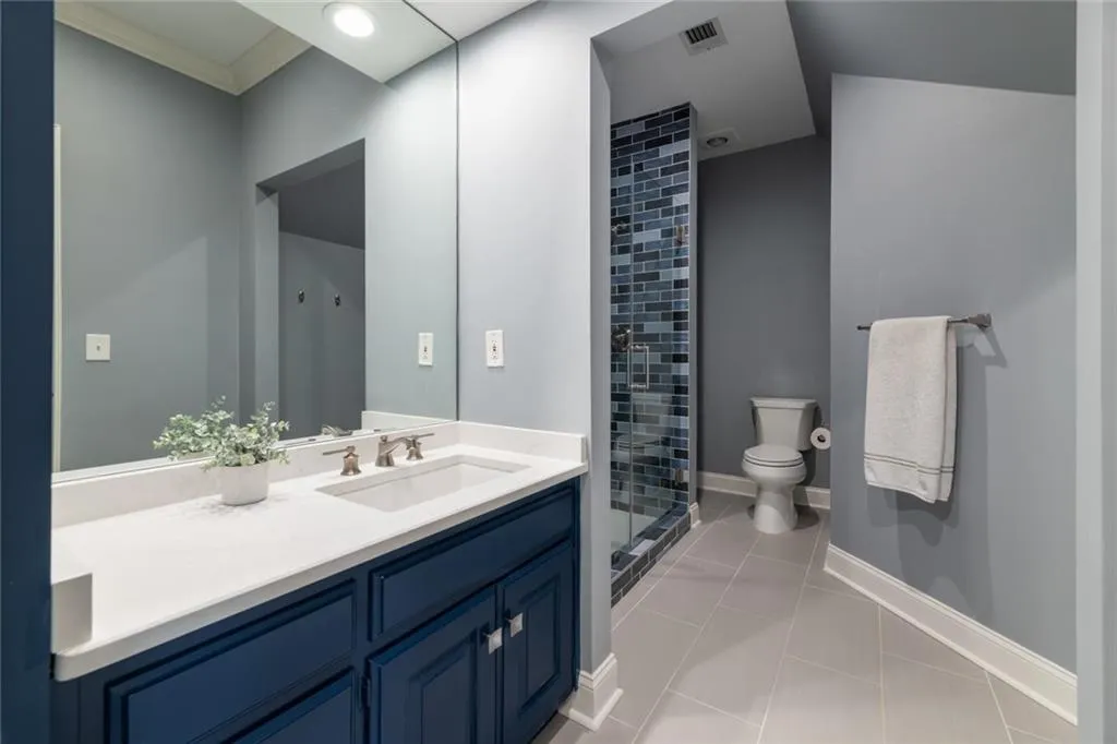 Remodeled ensuite in secondary bedroom on upper level.