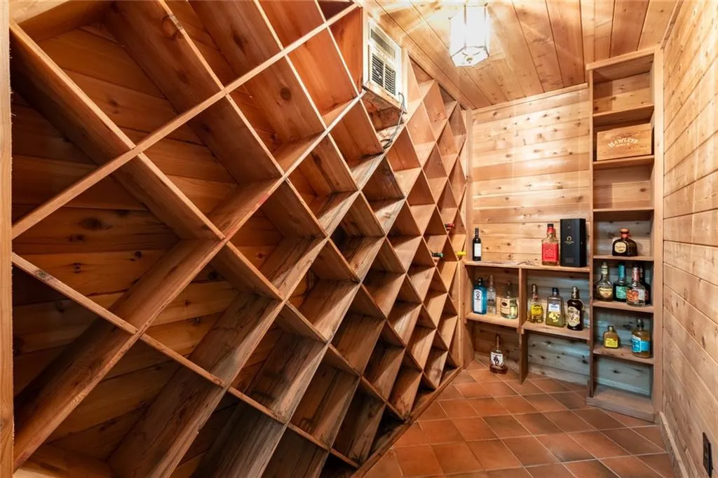 This beautifully crafted basement cedar wine cellar features custom wood racking and ample storage, creating the perfect environment for showcasing and preserving your collection.