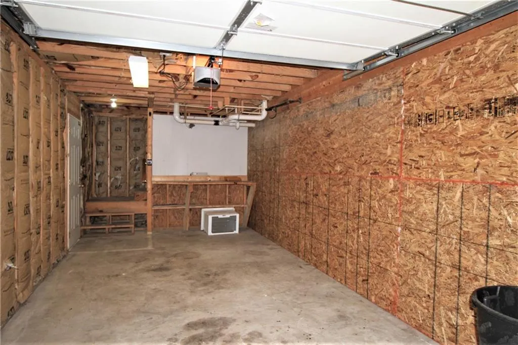 Garage featuring a garage door opener there are washer dryer hookups as well