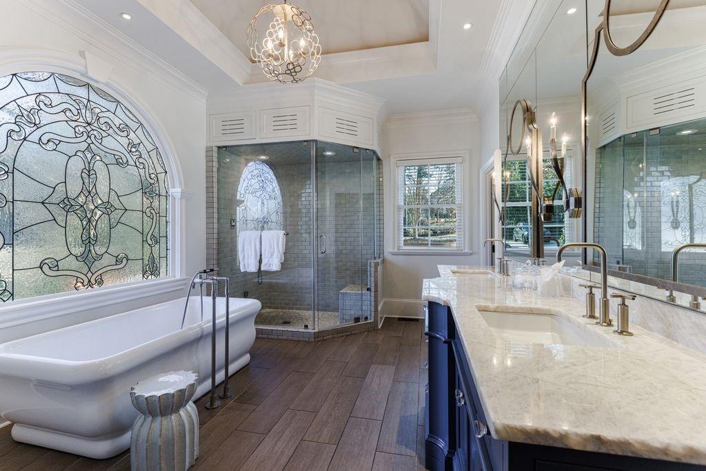 Luxurious primary suite bathroom with soaking tub, steam shower and double vanity.