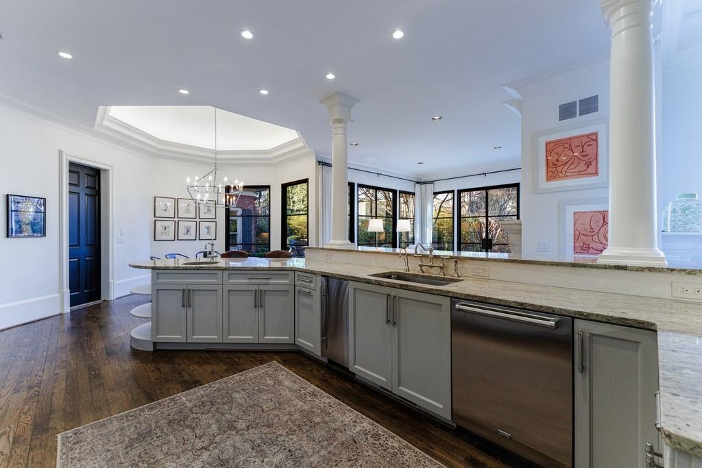 Kitchen with an inviting chandelier, sink, dark hardwood / wood-style flooring, and dishwasher