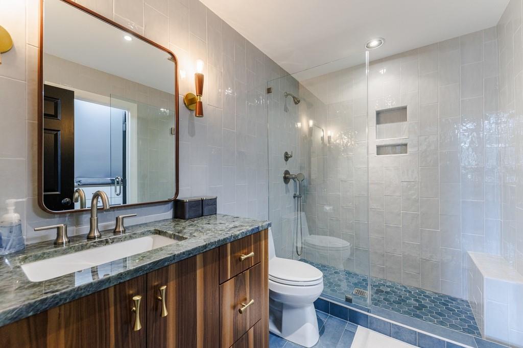 Renovated en-suite bath with stunning tile and vanity