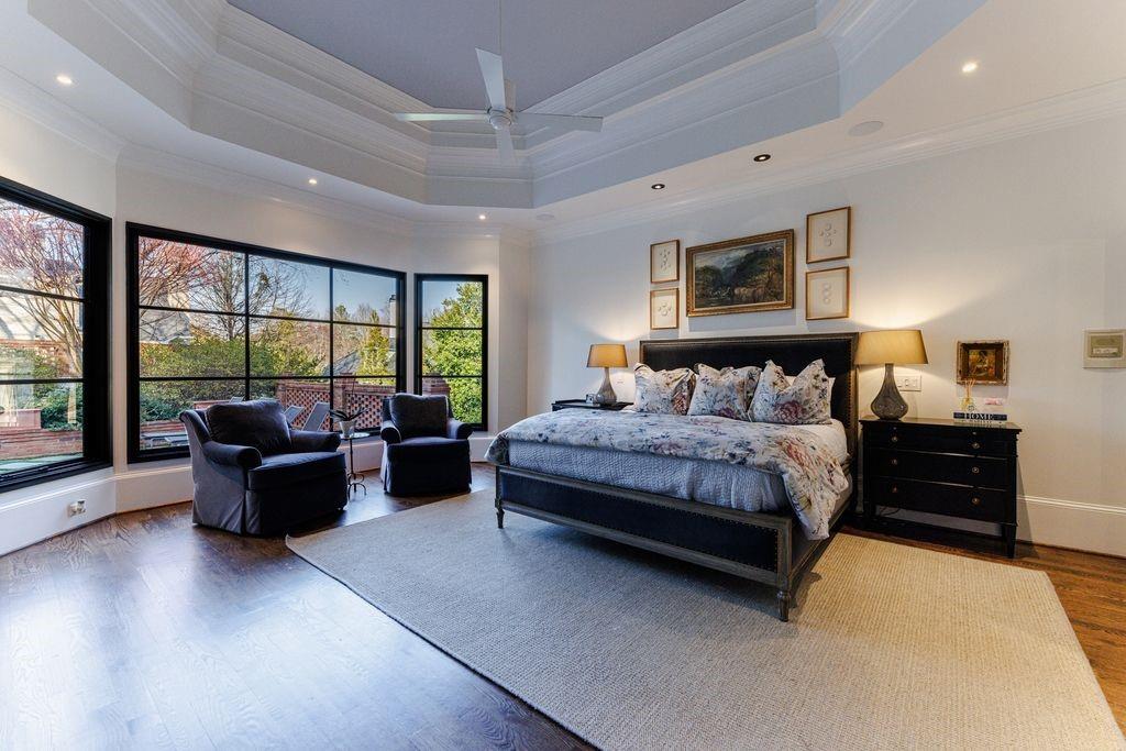 Large primary suite with sitting area and wall of steel windows