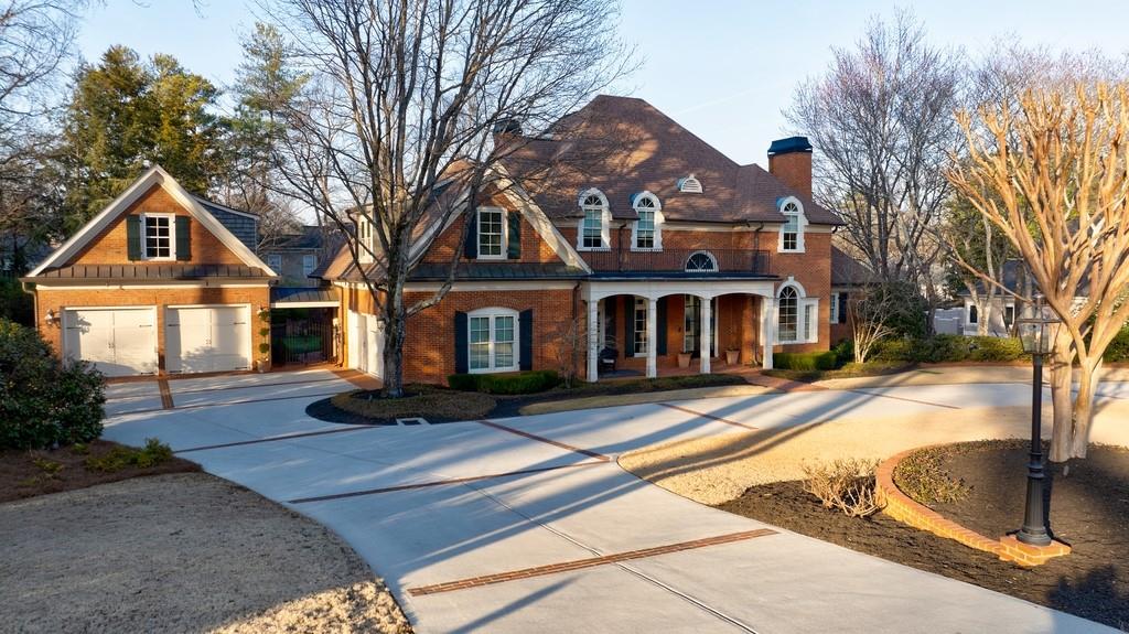 Renovated 4 side brick home with circular drive and 4 car garage.