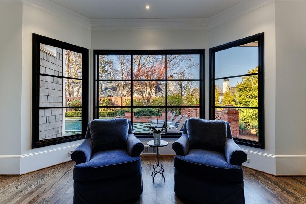 Living area featuring crown molding and dark hardwood / wood-style floors