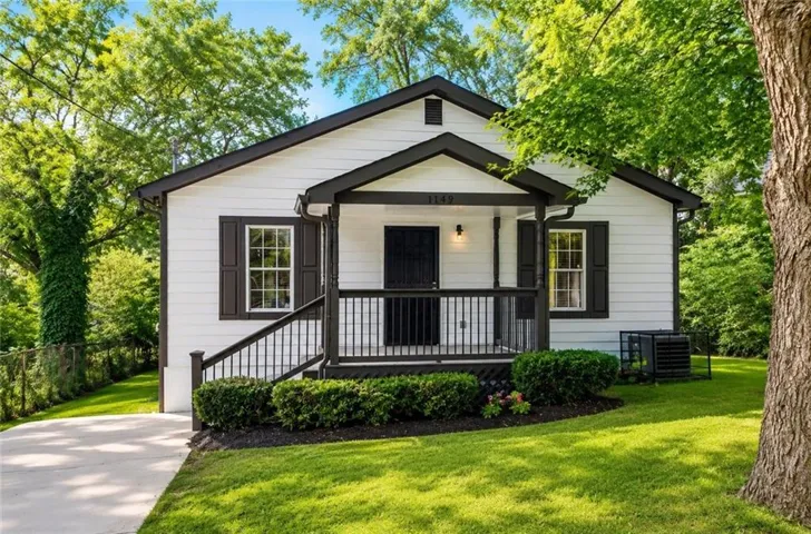 White siding exterior with dark trim and shutters