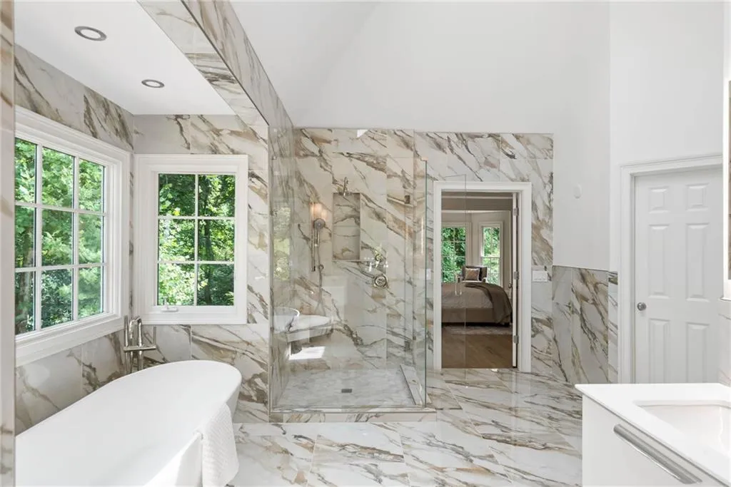 Bathroom featuring tile walls, vanity, and a wealth of natural light
