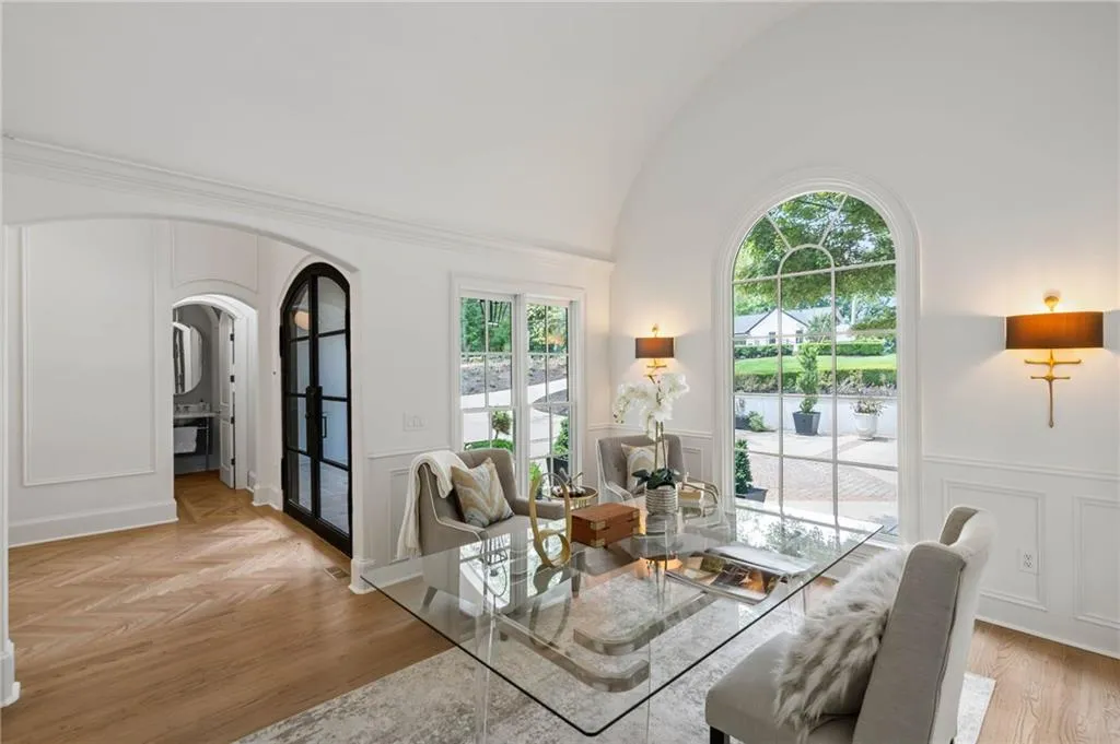 Dining area featuring light wood-type flooring, vaulted ceiling, and a healthy amount of sunlight