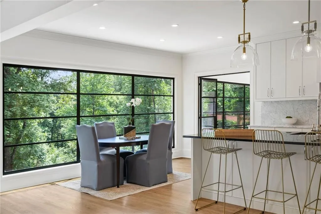 Dining area featuring ornamental molding and light hardwood / wood-style floors