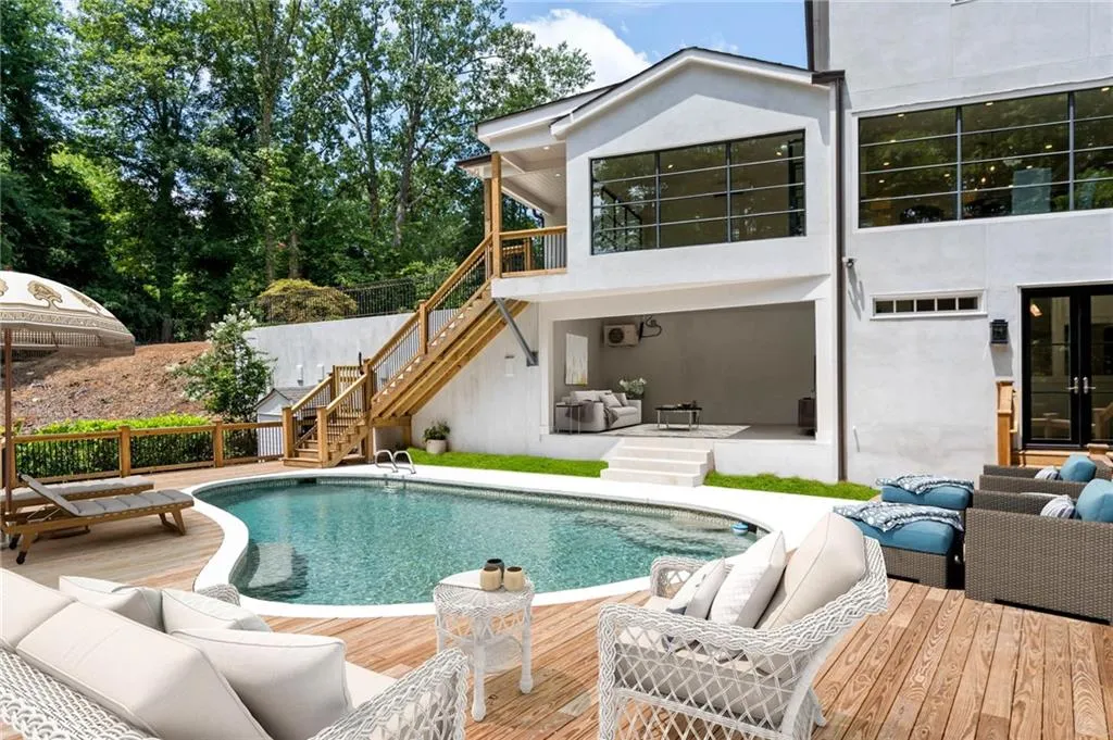 View of swimming pool with outdoor lounge area and a deck