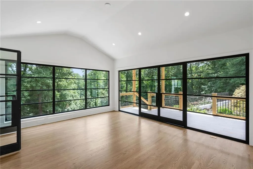 Empty room featuring light hardwood / wood-style flooring and lofted ceiling