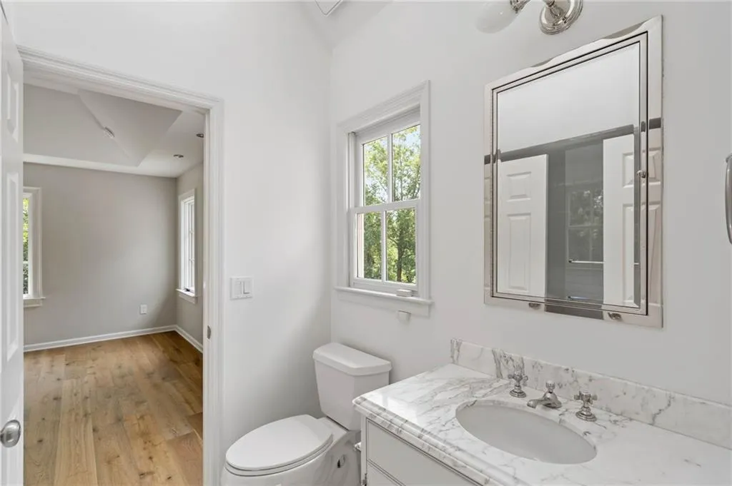 Bathroom featuring vanity, toilet, and hardwood / wood-style floors