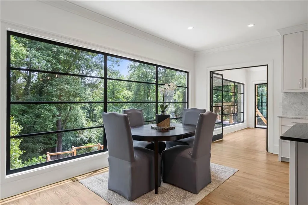 Dining area featuring ornamental molding, plenty of natural light, and light hardwood / wood-style floors