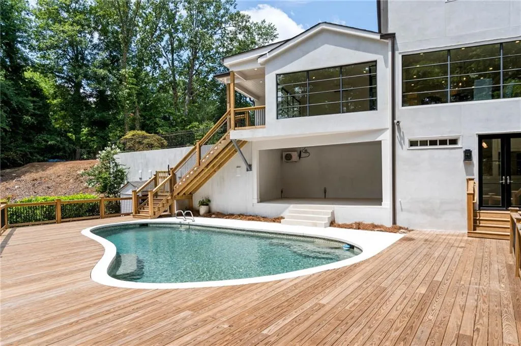 View of swimming pool with a wooden deck