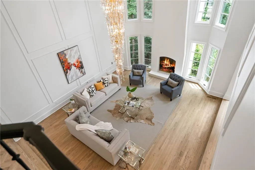 Living room featuring light wood-type flooring and a high ceiling