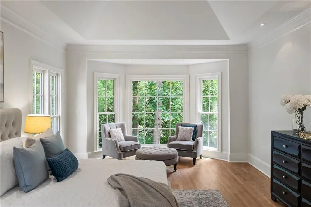 Bedroom featuring wood-type flooring and a tray ceiling