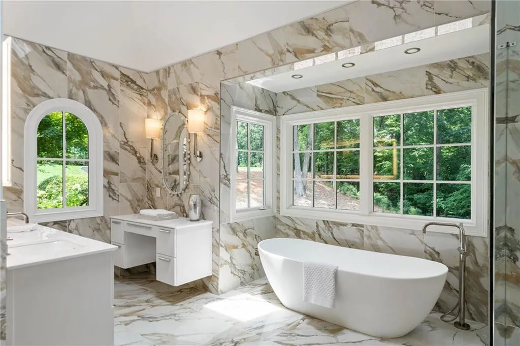 Bathroom with tile walls, plus walk in shower, vanity, and tile patterned flooring