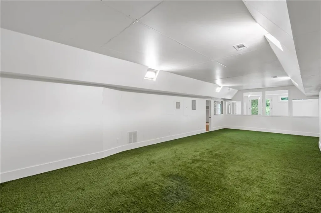 Soccer room or easily transformed into a golf simulator room/gym!