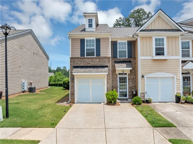 Multi-level townhome featuring brick and siding.