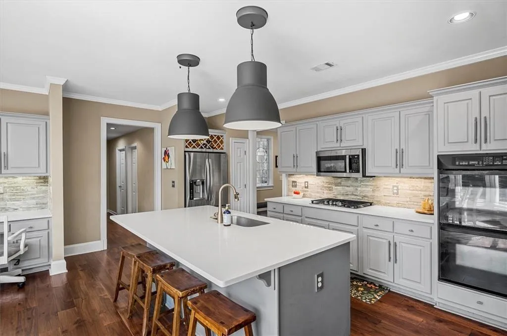 Hallway leads to garage, laundry room, full bath, and main level bedroom!