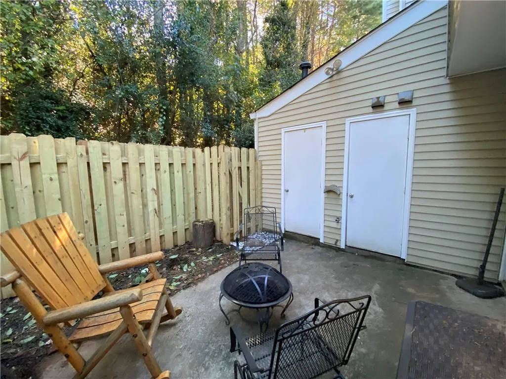 Fenced backyard featuring a patio area and a fire pit