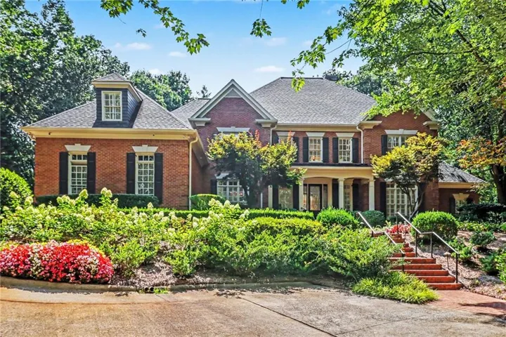 Traditional brick exterior featuring multiple gables and dormer windows