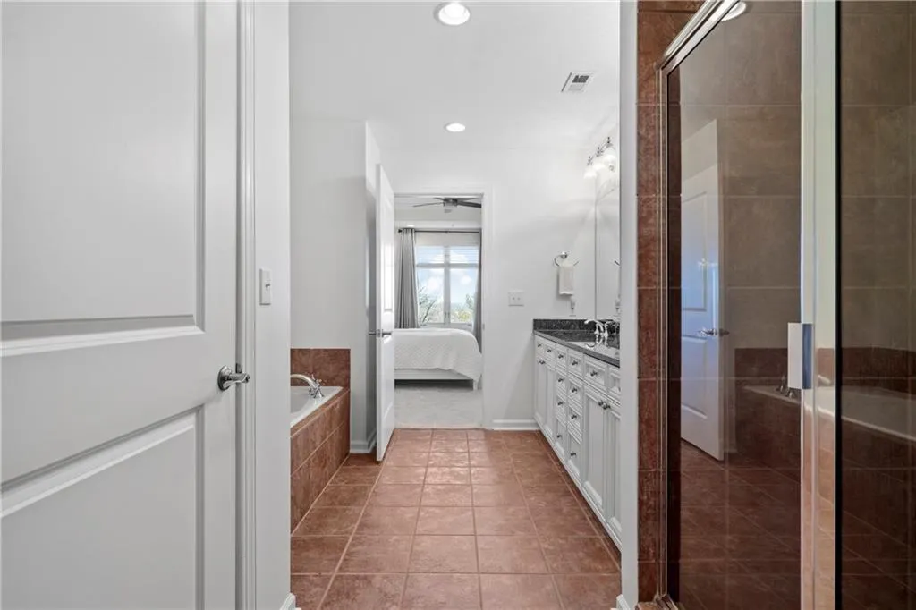 Bathroom with tile floors, separate shower and tub, and double vanity