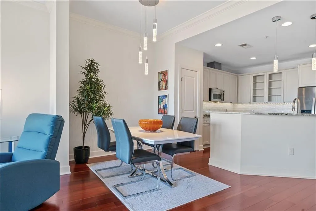 Dining area featuring ornamental molding and dark hardwood / wood-style floors