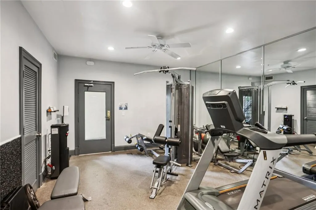 Exercise area featuring ceiling fan, recessed lighting, and carpet