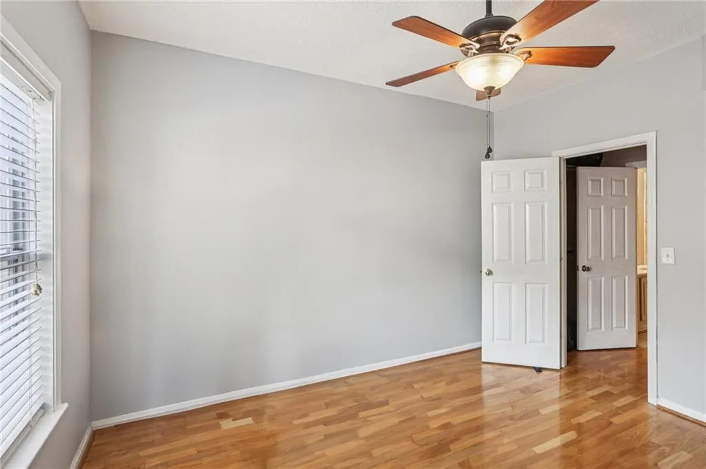 Unfurnished bedroom with light wood finished floors and a ceiling fan