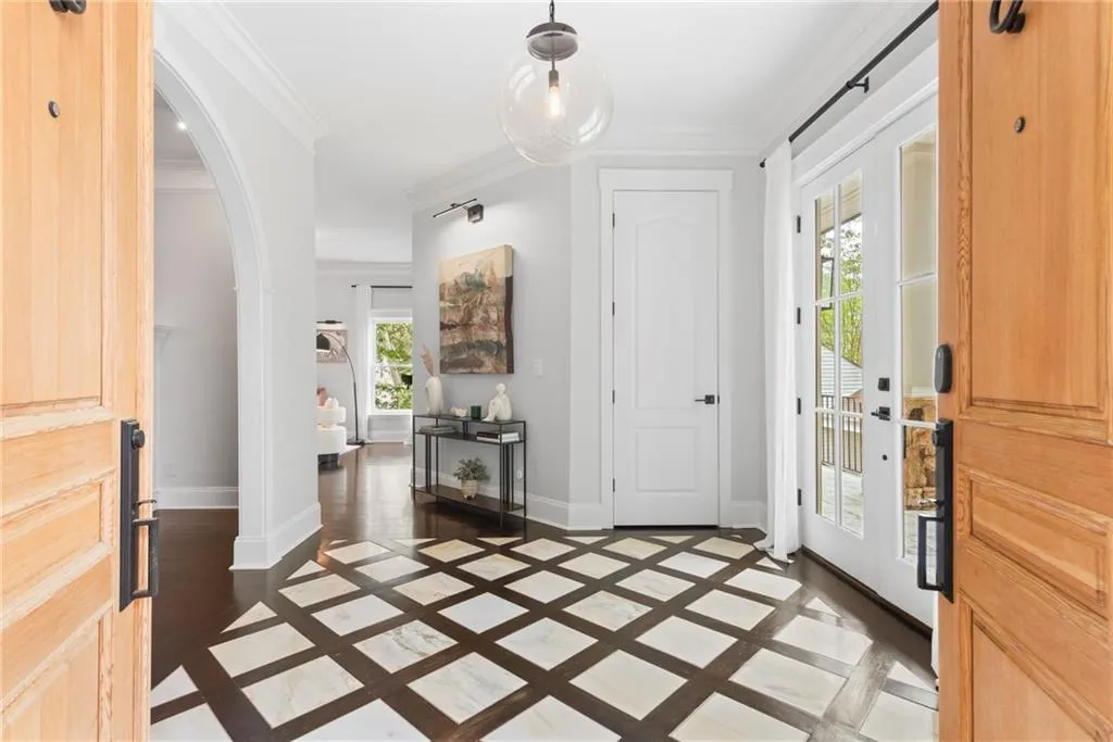 Beautiful doubke door entry to this great home - starts with stone floor.