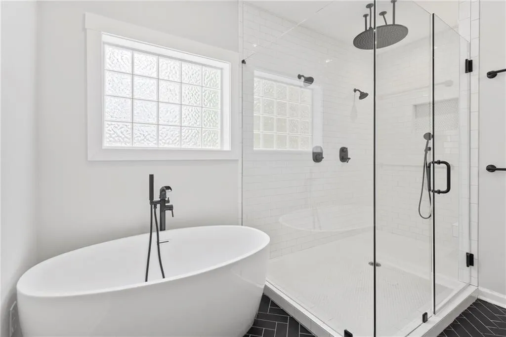 Soaking tub and three head shower with hand-held - look at that rain head!