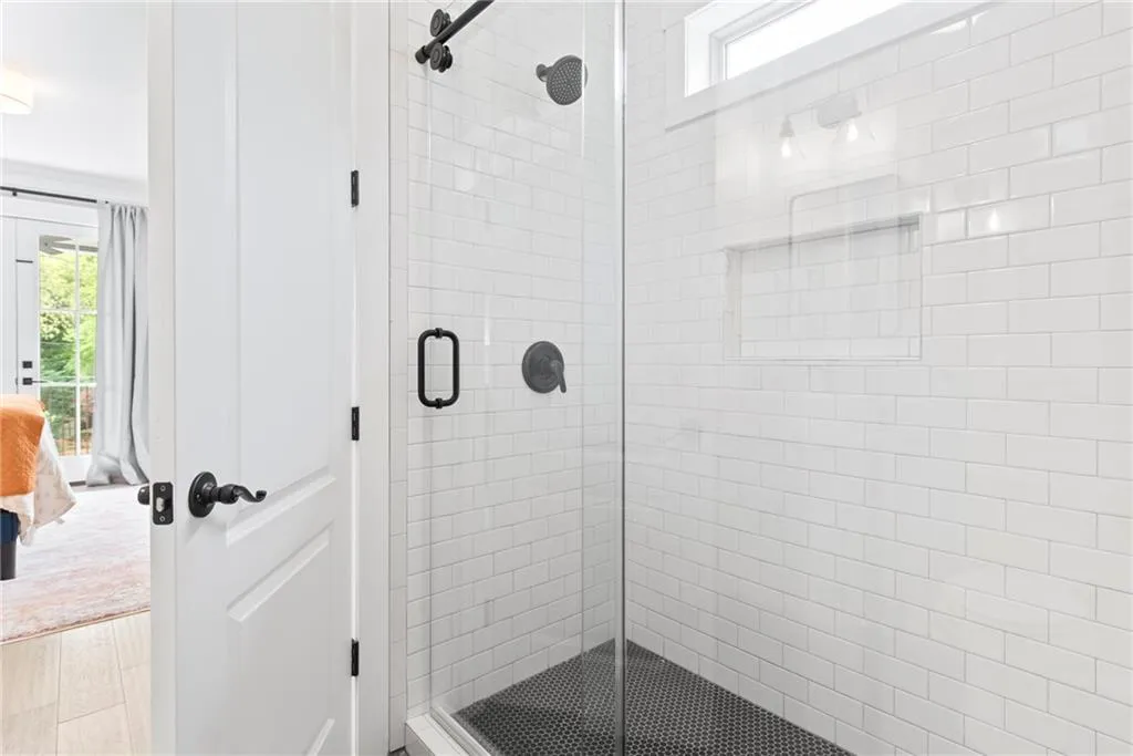 Transom window provides natural light and gleaming white tile
