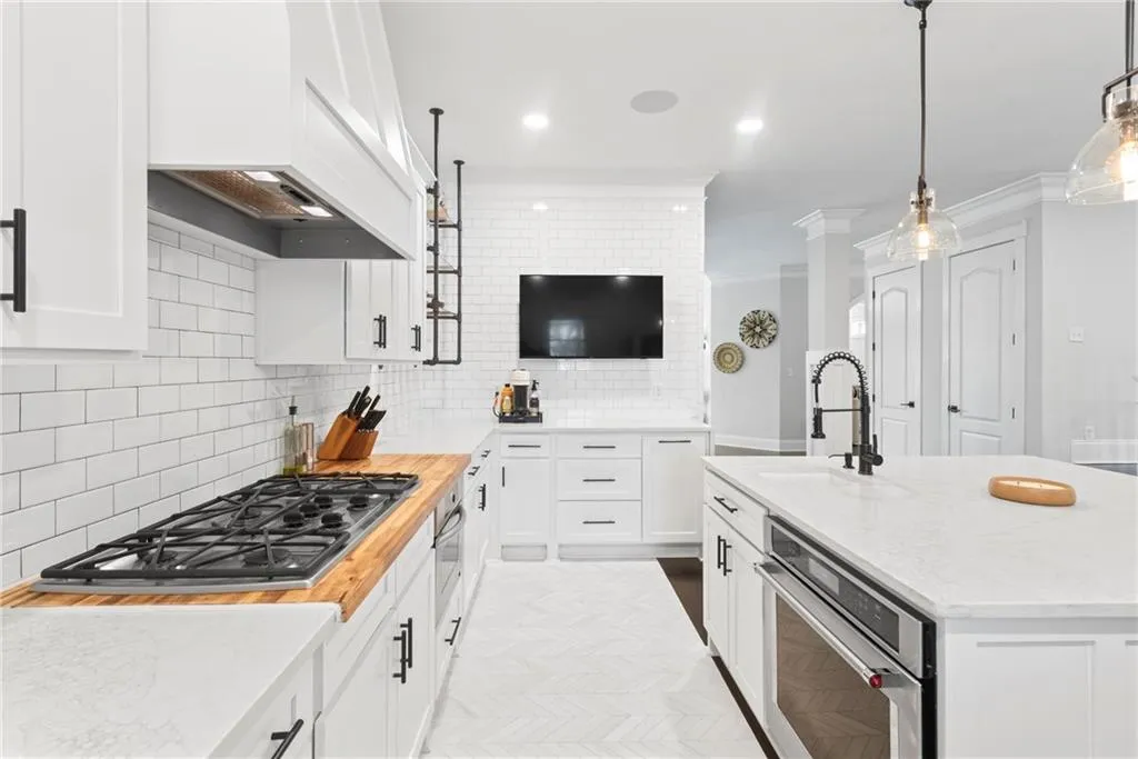 Great kitchen with all the modern conveniences - gas cooktop surrounded by butcher block