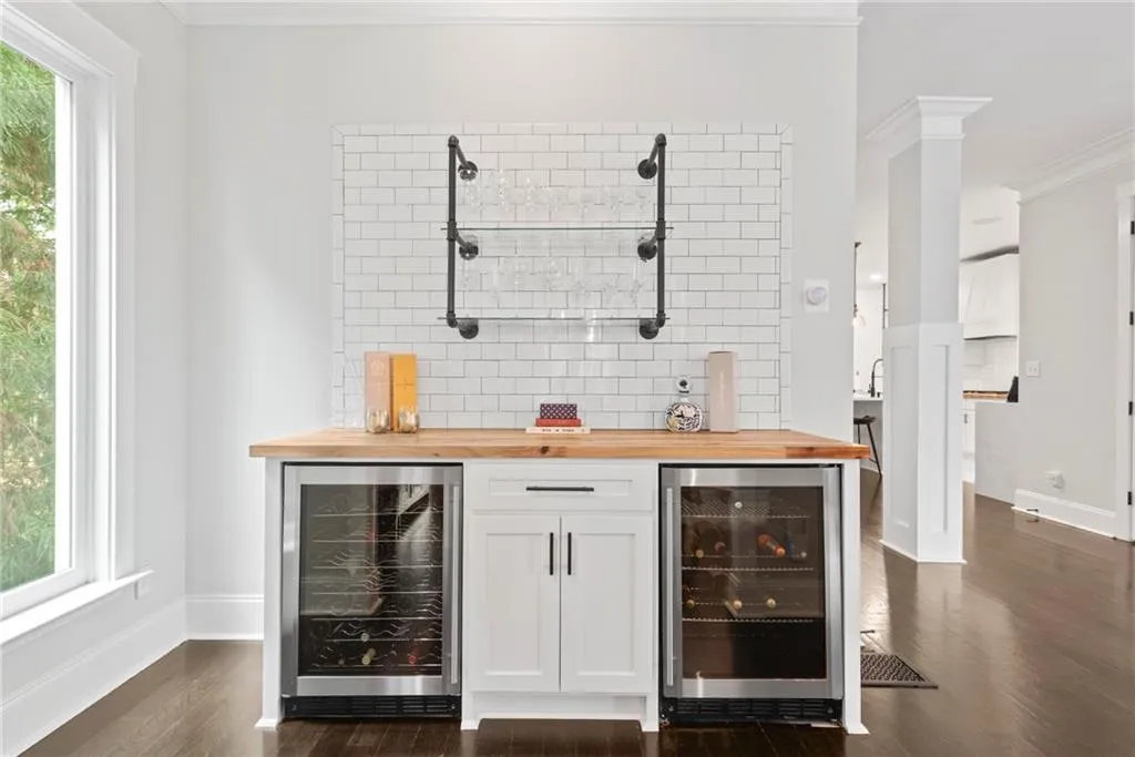 At the end of the dining room, adjacent to the living room and kitchen is a bar with wine and beverage chillers?